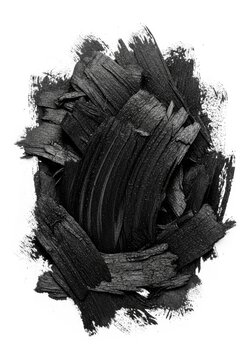Dense black charcoal smear featuring heavy grain and gritty textures on a white background with messy streaks and artistic abstract smudges, surface, material, ash