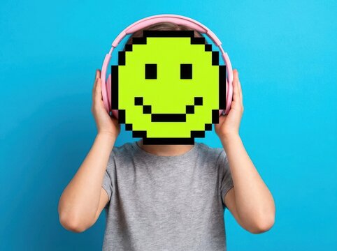 Happy pixelated smiley face emoji mask over person wearing headphones on blue background, isolated face replacement