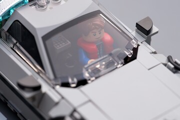 Fototapeta premium Tambov, Russian Federation - July 12, 2026 A close-up shot of a Lego Marty McFly minifigure sitting inside the DeLorean time machine car behind the windshield. Back to the Future.