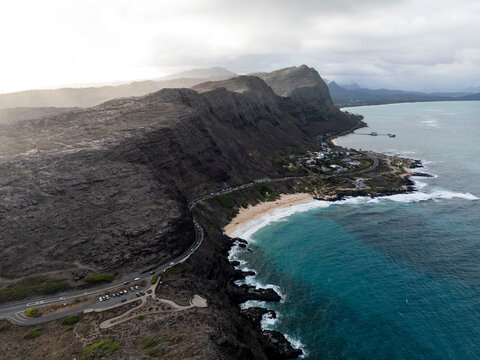 Aerial view of Makapuu Beach cove and coastal road at dusk, Oahu