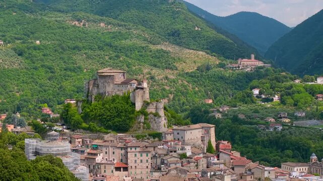 Rocca Abbaziale Subiaco Italy 4K Drone. Cinematic 70mm zoom out flight from medieval castle revealing mountain monastery. Golden ratio landscape compression b roll travel stock video asset