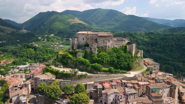 Subiaco Italy 4K Drone. Orbital aerial flight around medieval castle fortress on hilltop with town views. Hidden gem historic borgo village in green mountains landscape b roll cinematic video asset