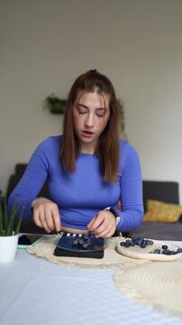 Vertical screen Even healthy food becomes a source of stress when obsessive calorie counting forces a young woman to weigh every blueberry before eating