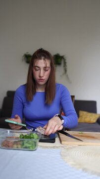 Vertical screen Extreme calorie control replaces healthy eating as a woman removes extra chicken from her meal to match every gram of her strict daily nutrition plan
