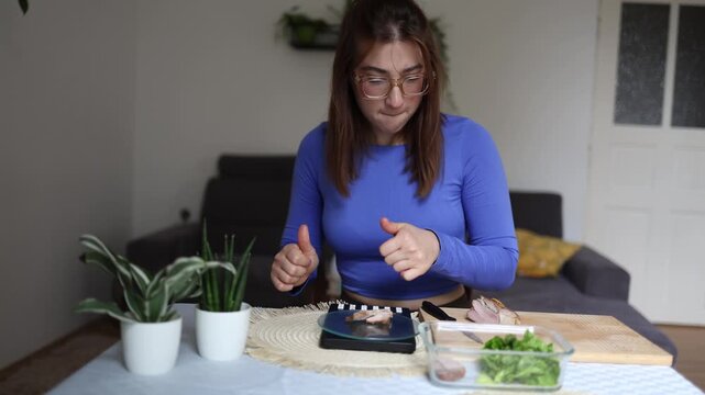 Calorie counting becomes a daily habit as fitness woman carefully weighs every bite before eating Showing modern obsession with weight loss portion control and nutrition