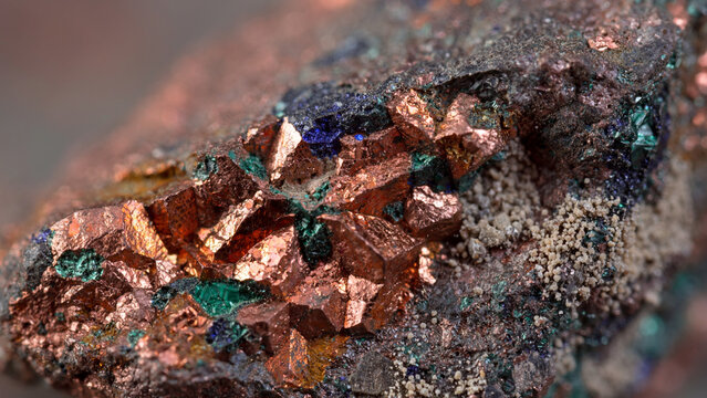 Extreme macro shot of native copper ore crystals mixed with green malachite mineral deposit