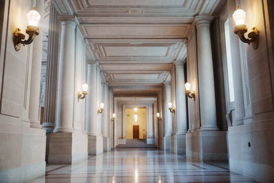 Elegant architectural details inside San Francisco City Hall, featuring ornate Beaux-Arts design, decorative columns, marble surfaces, intricate craftsmanship, and historic civic architecture.