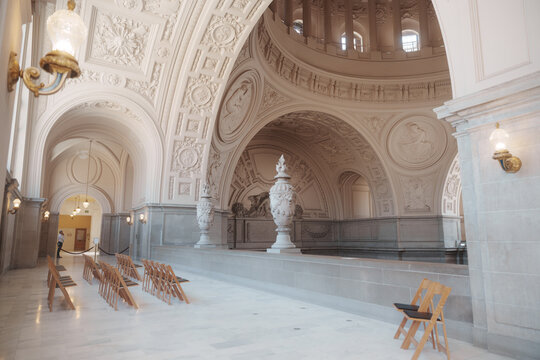 Elegant architectural details inside San Francisco City Hall, featuring ornate Beaux-Arts design, decorative columns, marble surfaces, intricate craftsmanship, and historic civic architecture.