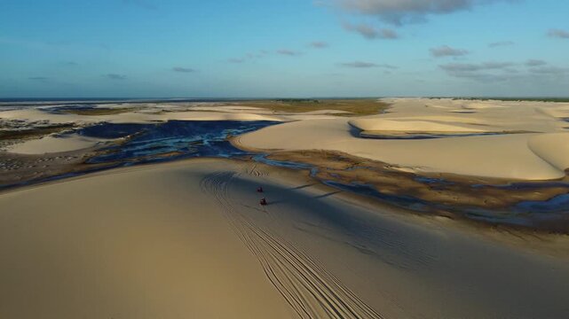 Two quad bikes crossing Len&ccedil;&oacute;is Maranhenses near Atins