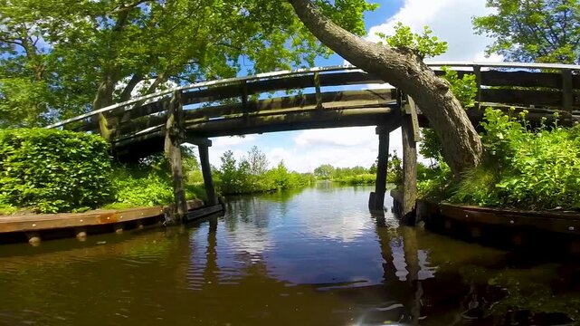 Point of view of a boat boat cruising through Dutch channels, Netherlands
