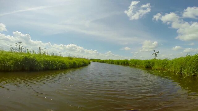 Point of view of a boat boat cruising through Dutch channels, Netherlands