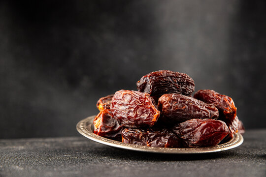 Dates sweet dessert edible fruits of the date palm food preparation tasty snack fresh and delicious gourmet food background on the table rustic food top view copy space keto and paleo diet 