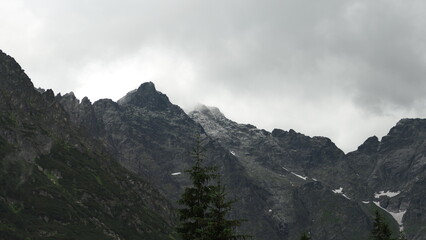 Jagged rocky Tatra Mountains peak with drifting clouds, Poland © Dovis