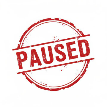 Red round rubber stamp with the word paused written in the center