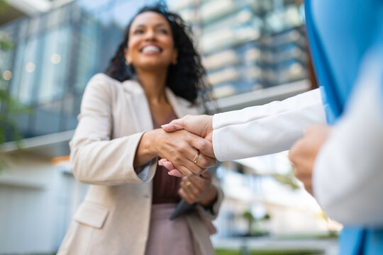 Businesswomen shaking hands completing a corporate agreement