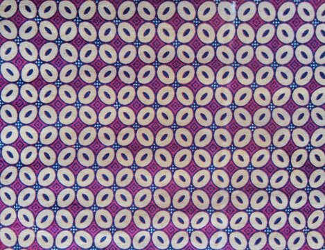 Colorful geometric batik textile pattern with repeating oval motifs.