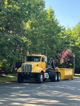 Seattle, WA, USA
July 16, 2026
Yellow dumpster truck