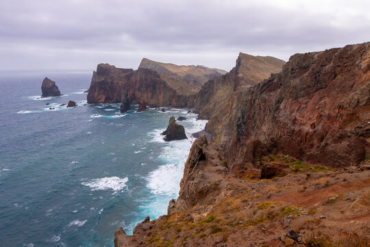 Rugged volcanic coastal landscape with high cliffs and crashing waves at Ponta de Sao Lourenco in Madeira