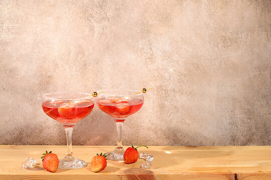Refreshing summer lemonade cocktail, a mojito with strawberries, and iced soda, perfect summer party concept,bright, sunny summer banner serves as a menu promotion for a caf or bar.Modern still life
