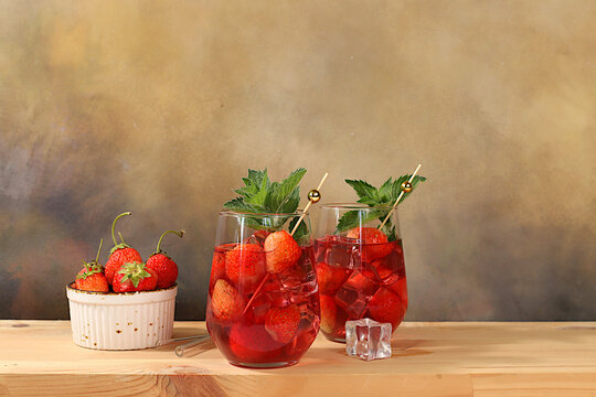 .Refreshing summer homemade lemonade cocktail and non-alcoholic mojito, strawberry iced tea with berries, mint and lemon, weight loss concept, detox water with fruit flavor on light background.