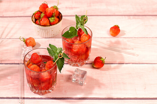 Refreshing summer lemonade cocktail, a mojito with strawberries, and iced soda, perfect summer party concept,bright, sunny summer banner serves as a menu promotion for a caf or bar.Modern still life