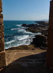Fototapeta premium Ocean view from stone arch in Essaouira medina, Morocco overlooking rocky coastline