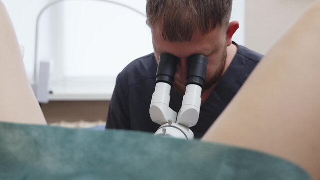 Gynecologist performing a colposcopy examination using a colposcope in a modern medical clinic. Concept women's health, gynecology, cervical screening, preventive medicine, medical diagnostics.