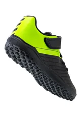 Black and neon yellow turf soccer shoe isolated on white background, vertical shot © ValentinValkov