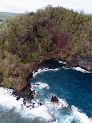 Aerial view of a forested lava rock cove at Waianapanapa State Park, Maui © Zach