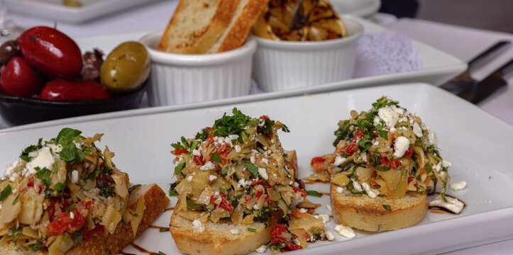 Artichoke bruschetta trio with feta, olives and toasted bread