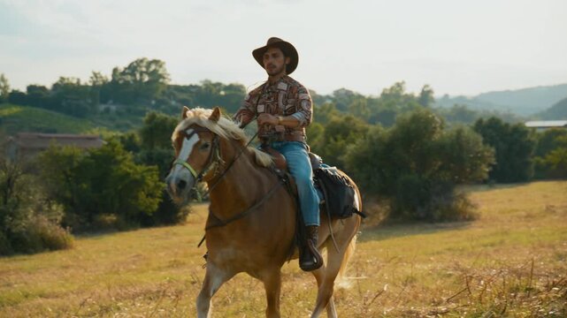 Cowboy man calmly rides horseback on a ride in the pristine nature
