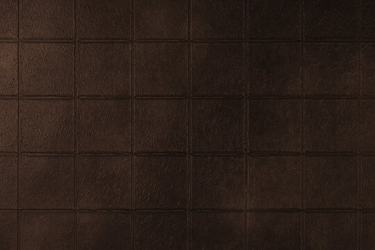 Dark brown ceramic tile texture background with square pattern and subtle grunge surface. Abstract geometric wall backdrop with textured tiles and copy space. Interior element, vintage design
