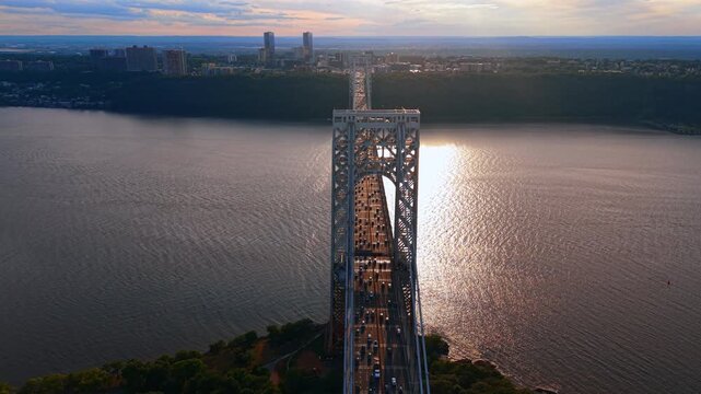 Flight over the George Washington Bridge with terrible traffic on. Numerous cars move by the multi-lane highway of bridge at sunset. New York City, USA.