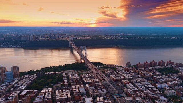 Flying over the residential blocks at the Hudson River waterfront. Approaching the George Washington Bridge at sunset.