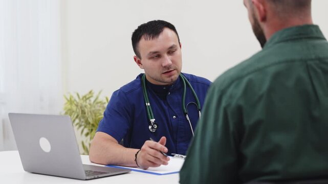 Young man consulting a family doctor during a routine health visit. Concept preventive healthcare, medical consultation, primary care, healthy lifestyle, wellness.