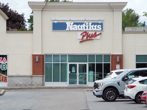 Gatineau,Quebec, Canada &ndash; May 27, 2026: The exterior of this "Nautilus Plus" centre de conditionnement physique features large glass windows and a parking lot with cars at 203 Chem. d'Aylmer.