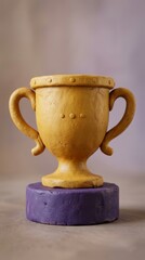 Fototapeta premium Golden clay trophy on purple pedestal for academic winner 3D render