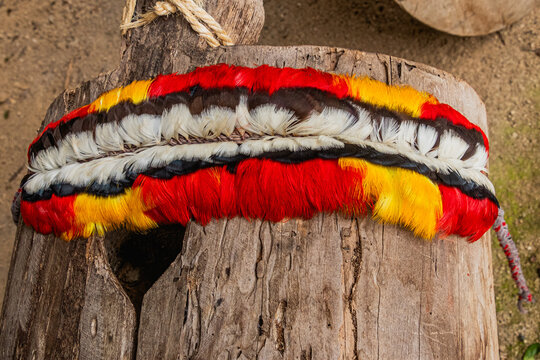 Traditional Shuar indigenous crown decorated with toucan feathers on a wooden background. Ecuadorian Amazon