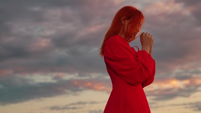 Young Christian woman praying dawn. Woman confessing faith in God. Woman praying family children against sky. Relaxation, meditation, nature. Apologizing. Hope. People of religion. Woman dream Love