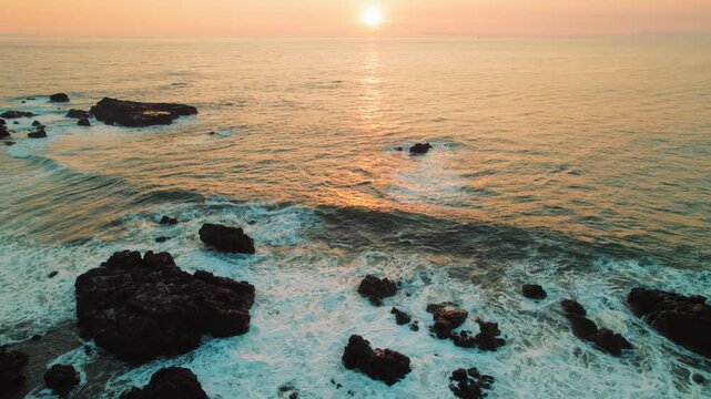Sunset view over rocky coastline with Pacific Ocean in Jaco Costa Rica
