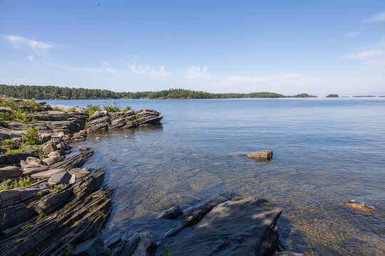 Stunning view of Georgian Bay from Lighthouse Trail at Killbear Provincial Park, Ontario, showcasing rocky shoreline and serene waters.