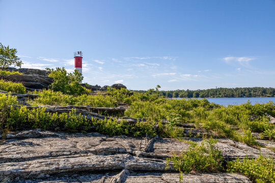 Vibrant lighthouse and rugged landscape of Killbear Provincial Park, Ontario.