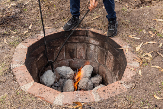 The traditional Andean process of preparation of Pachamanca, a communal method of cooking meats and root vegetables over hot stones placed in an underground earth oven