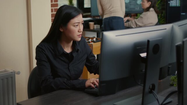 System engineer reacts to a compiling problem during algorithm work, reviewing code results and troubleshooting an issue at the workstation