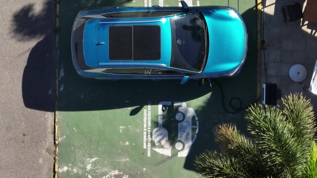 Electric Car Charging. The sustainable future of mobility powered by clean, sustainable energy that causes no harm to the planet. Aerial view.