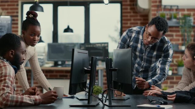 Mixed software development team develops interface concepts around programming data, using office collaboration to refine cloud software workflow and UI logic, while managing digital system logic.