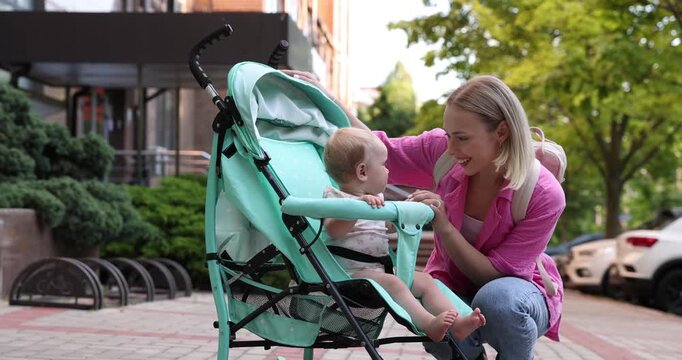 Baby carriage. Mother and her child in stroller outdoors