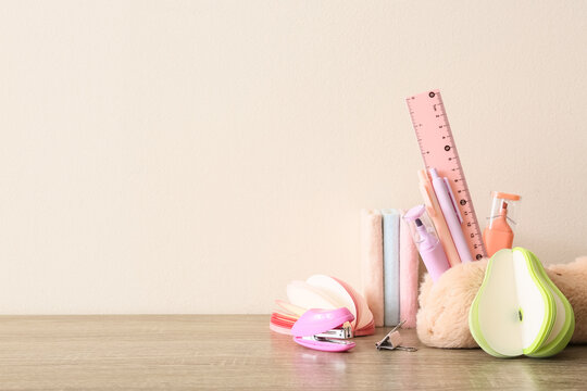 Pastel school supplies and office stationery on a wooden desk with copy space for education and creativity