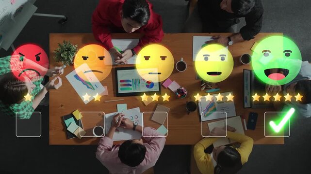 Top view of a diverse team engaging in a collaborative meeting surrounded by charts and digital devices, fostering creativity and strategic planning in a modern workspace. Raster