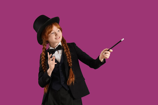 Young magician showing magic trick on purple background